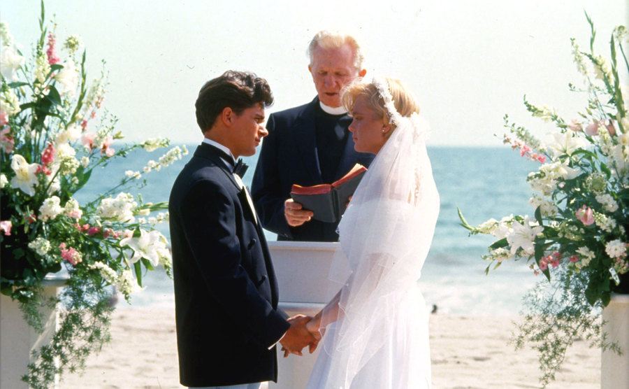 Eleniak and Warlock are getting married in a still from Baywatch. 