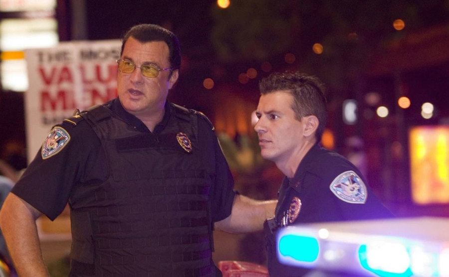 Steven Seagal talks to a police officer in a still from Steven Seagal: Lawman. 