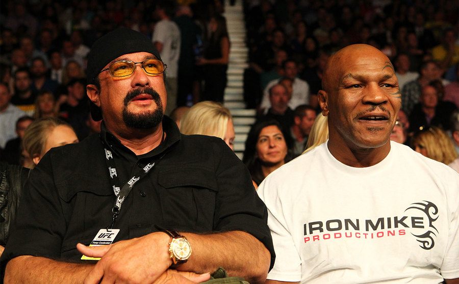 Steven Seagal and former boxing champion Mike Tyson look on during a fight. 