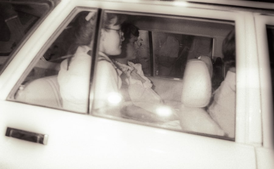 An image of Lindy sitting inside a car arriving in court.