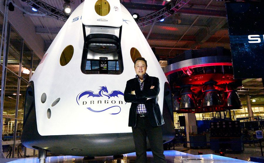 An image of Elon Musk standing next to a new spacecraft.