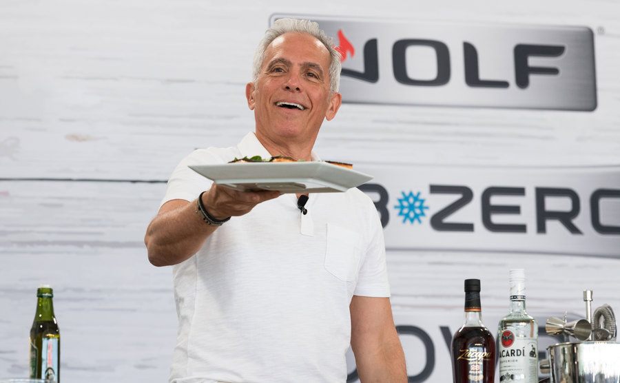 A picture of Geoffrey Zakarian cooking on stage.
