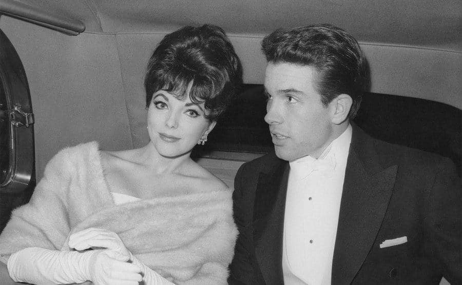 Joan Collins and Warren Beatty are in the back of a limousine