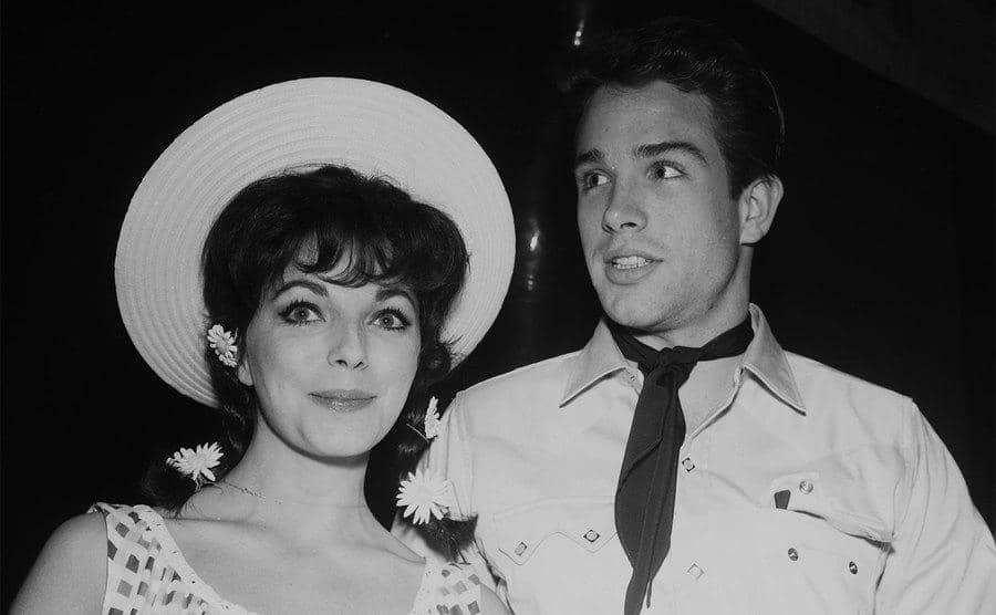 Warren Beatty and Joan Collins attend a party