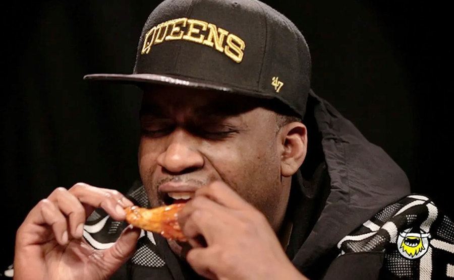 Tony Yayo takes a bite out of a spicy hot wing. 