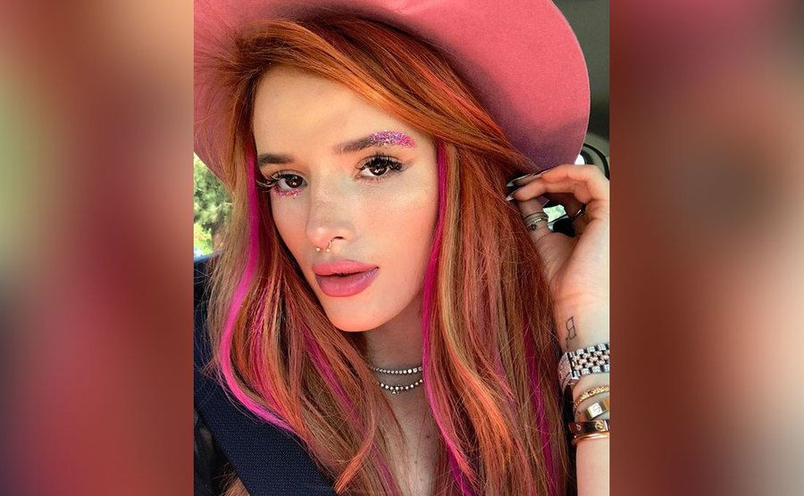 A selfie of Bella Thorne showing off a crazy pink makeup look. 