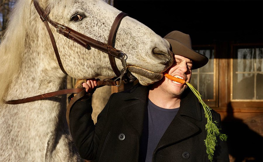 Fraser eats a carrot out of his horse’s mouth. 