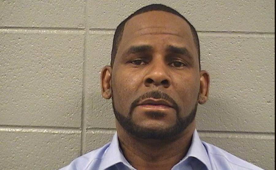 R. Kelly poses for a mugshot photo after being arrested. 