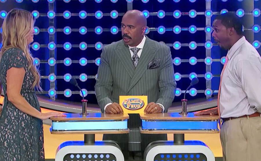 Contestants face off on the set of Family Feud. 
