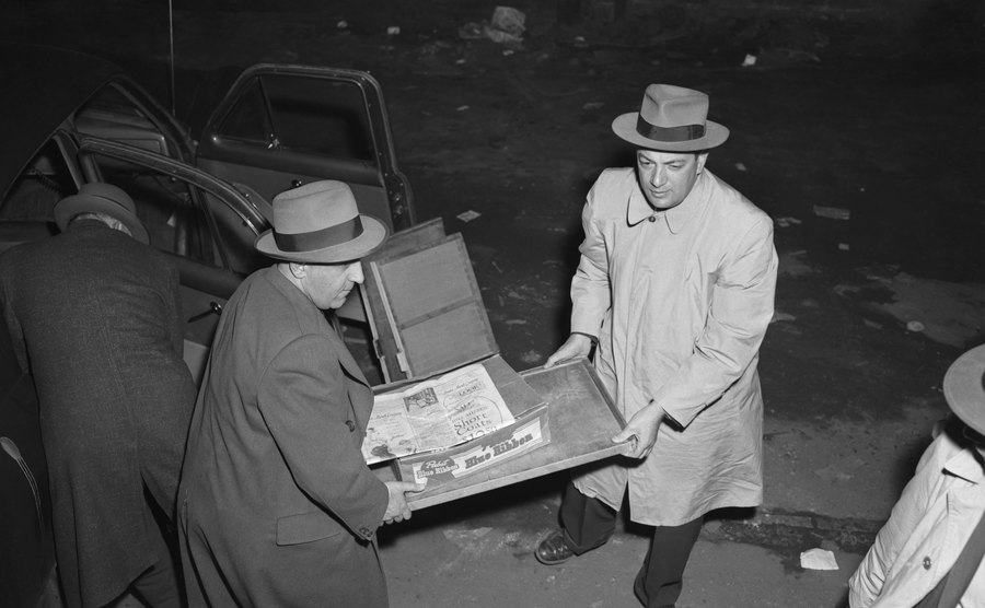 An image of FBI agents carrying a box of money.