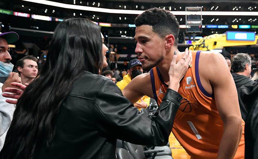 Kendall Jenner and Devin Booker kiss and hug after the game. 