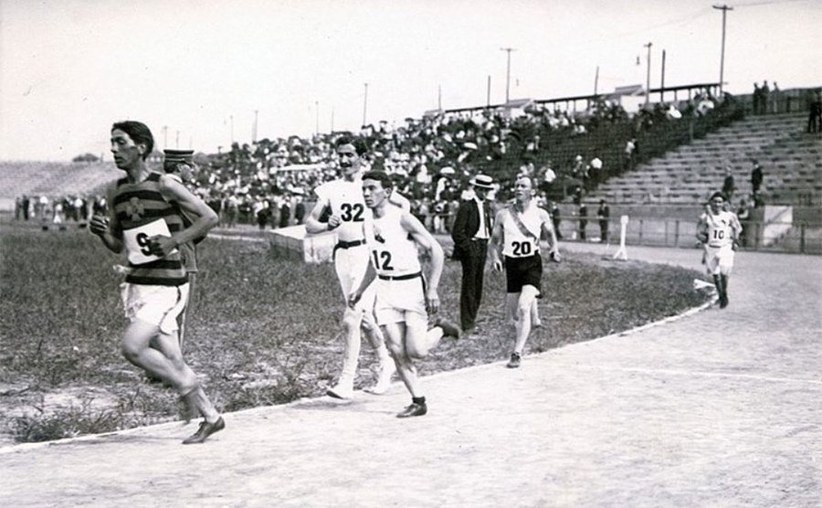 The runners set off from the stadium on a hot summer day.