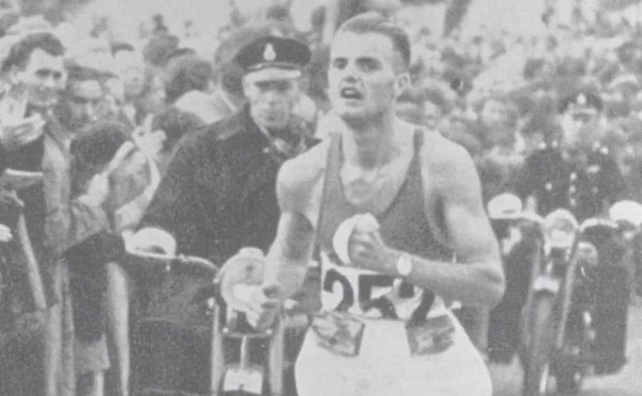 A photo of Etienne Gailly crossing the finish line.