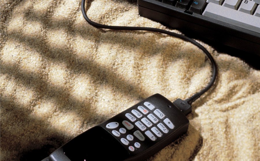 A photo of a telephone connected to a laptop computer.