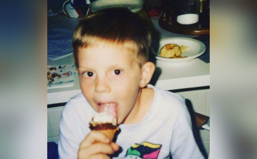 Evan Peters as a toddler is eating an ice cream. 