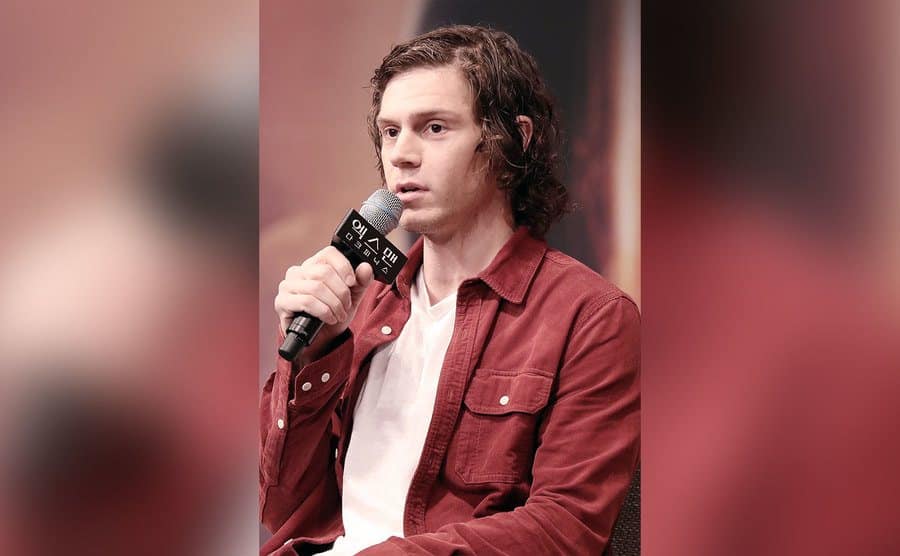 Evan Peters speaks during the press conference. 