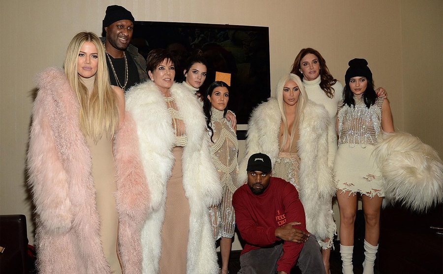 Kanye poses with the Kardashians. 