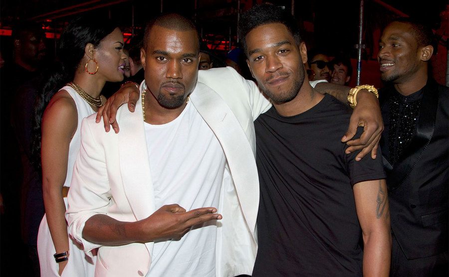 Kanye West and Kid Cudi attend an event. 