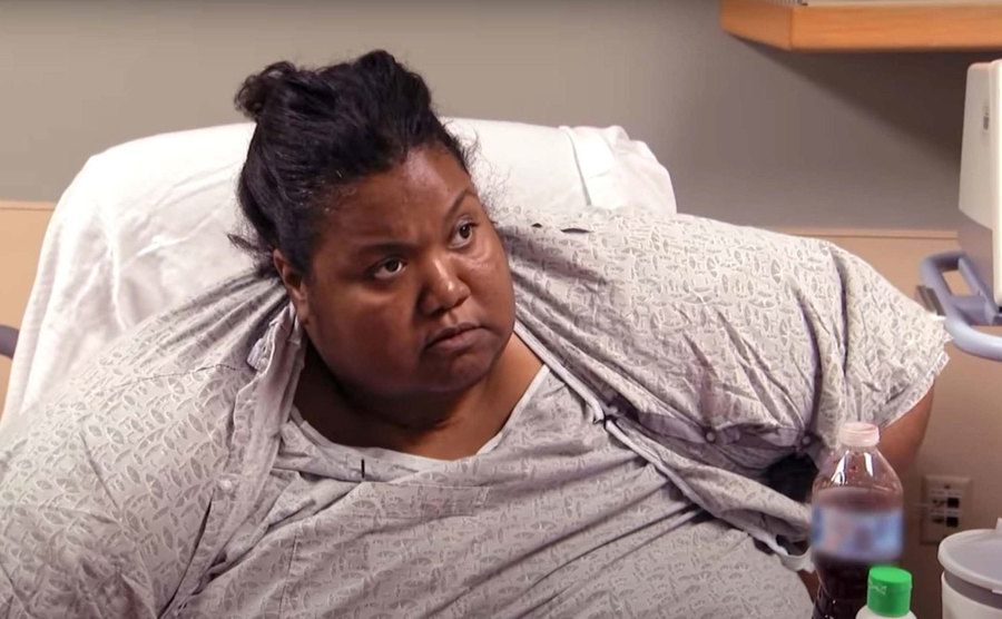 An obese woman is in a hospital bed. 