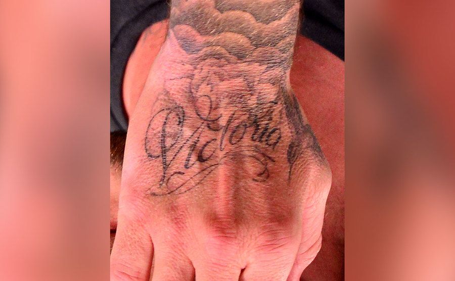 A close-up on David Beckham’s tattooed hand. 