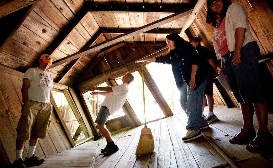 People stand in a slant inside the Oregon Vortex. 