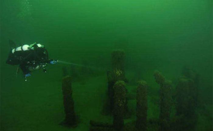 A diver explores the underwater Stonehenge. 