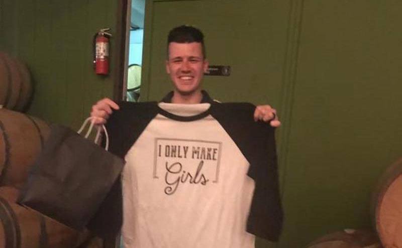 Chris holds up a shirt that says “I only make girls”.