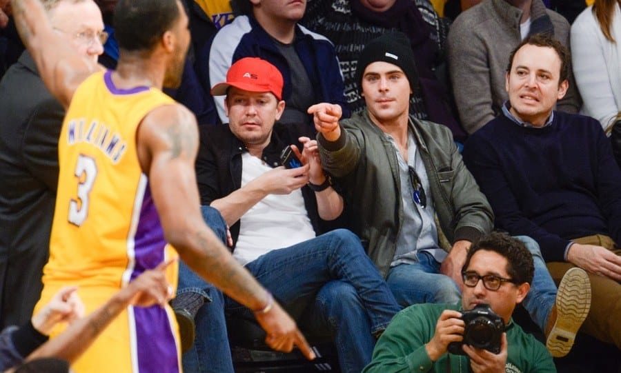 Zac Efron attends a basketball game 
