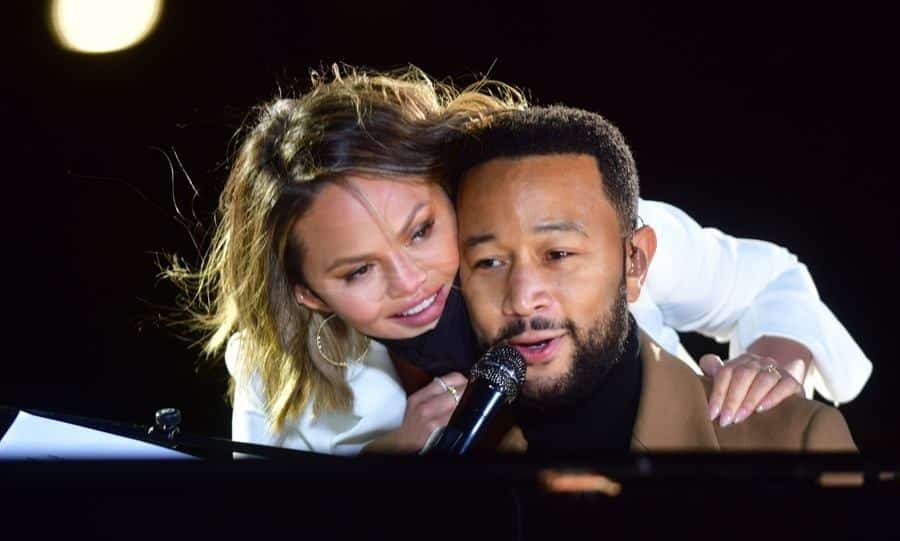 Singer John Legend is joined onstage by his wife, Chrissy Teigen